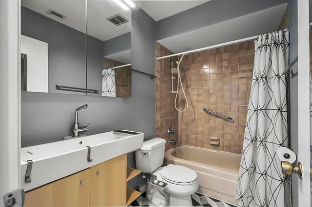 a view of a bedroom with furniture and windows