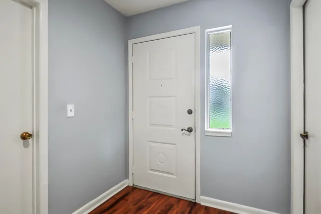 a view of front door with wooden floor