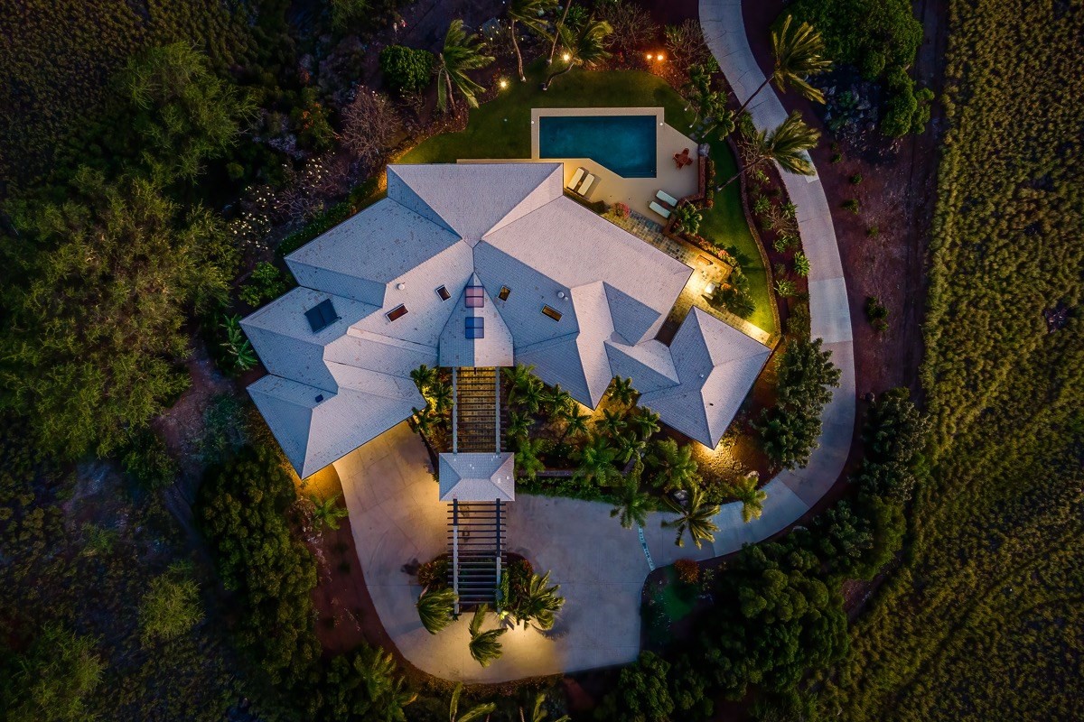 an aerial view of a house with garden space and street view