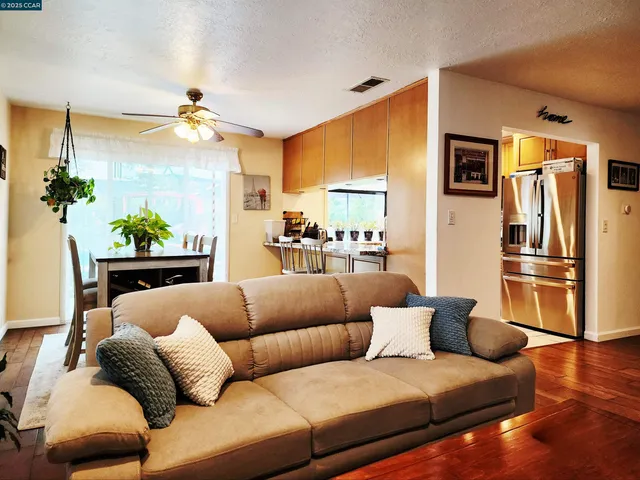 a living room with furniture fireplace and a chandelier