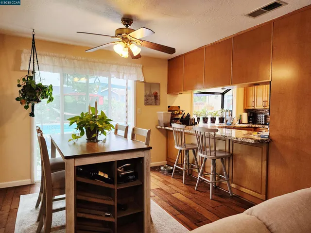 a view of a dining room with furniture and a potted plant