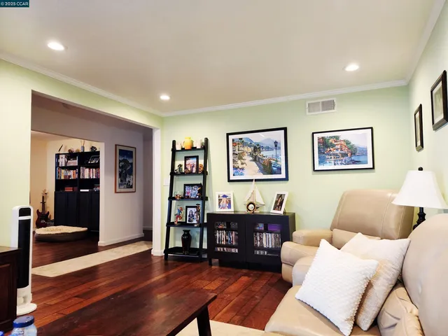 a living room with furniture and a book shelf