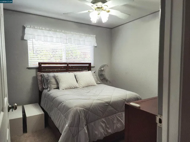 a bedroom with a bed and window