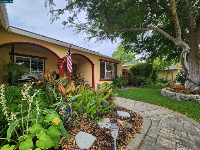 a front view of a house with garden