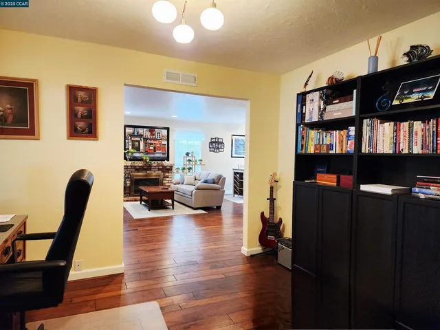 a living room with furniture and a book shelf