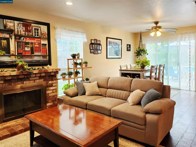 a living room with furniture a lamp and a fireplace