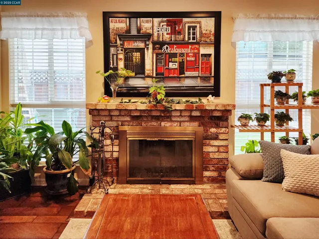 a living room with furniture a fireplace and windows