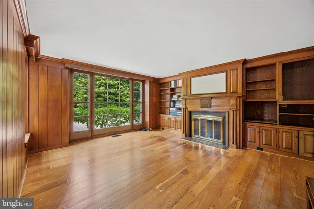 a view of a livingroom with furniture hardwood floor and a fireplace