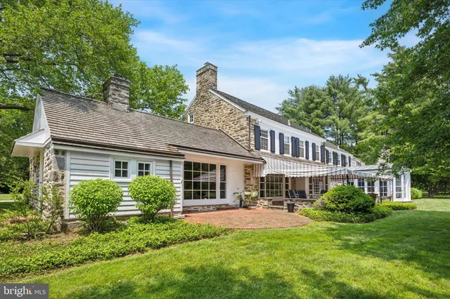 a front view of a house with a yard table and chairs