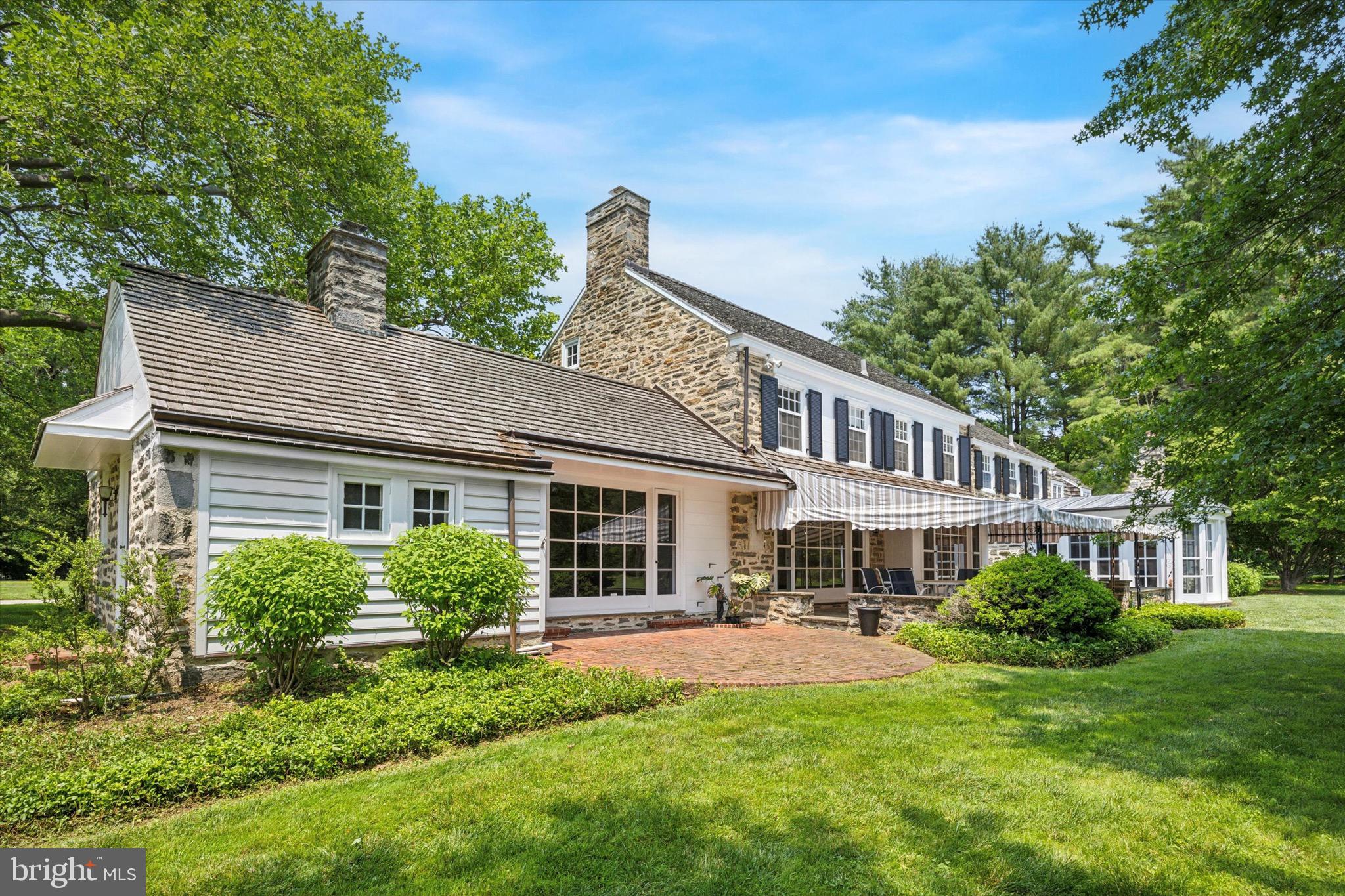 1024 North Spring Mill Road Villanova, PA 19085 - Photo 28 of 34 a front view of a house with a yard table and chairs