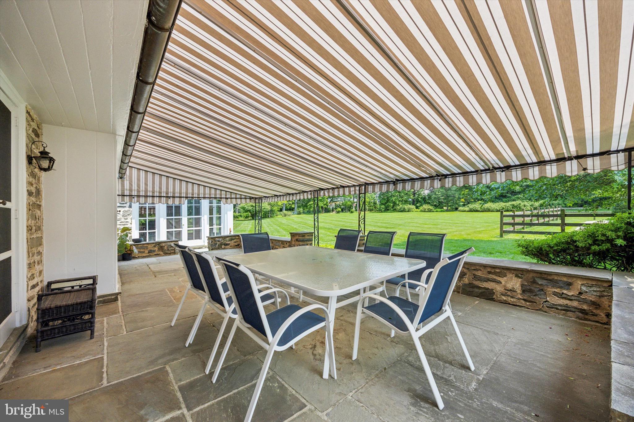 1024 North Spring Mill Road Villanova, PA 19085 - Photo 29 of 34 a patio with table and chairs and potted plants