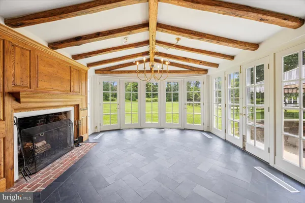 a view of an empty room with a fireplace and a window