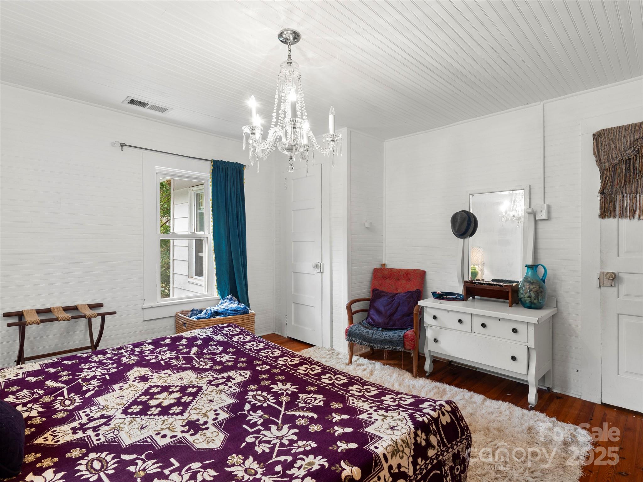27 Barkn Cove Canton, NC 28716 - Photo 18 of 32 a bedroom with a bed chandelier and a window