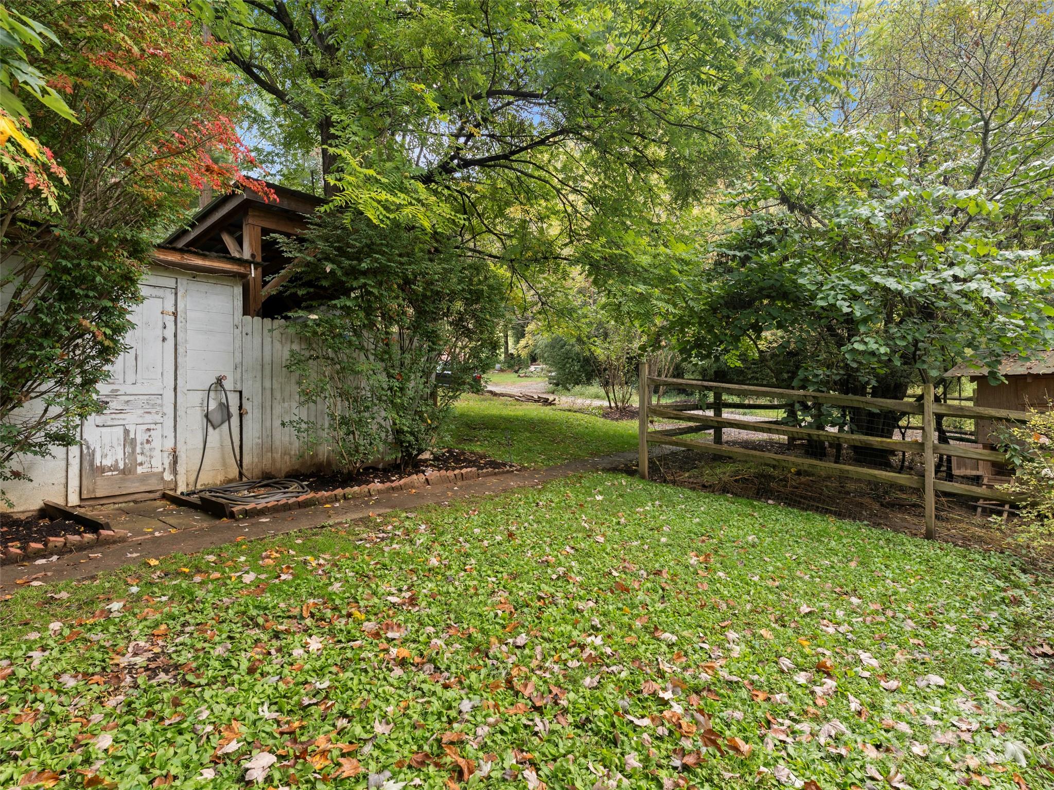 27 Barkn Cove Canton, NC 28716 - Photo 28 of 32 a view of backyard with wooden fence and a large tree