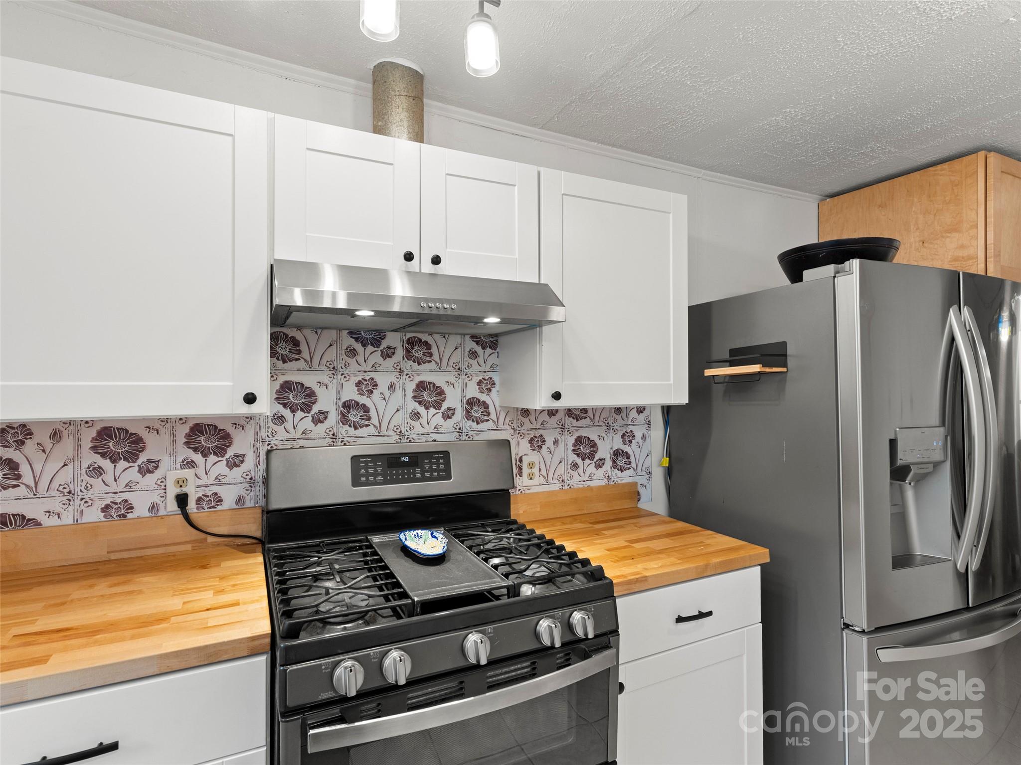 27 Barkn Cove Canton, NC 28716 - Photo 9 of 32 a kitchen with stainless steel appliances granite countertop a stove and a refrigerator