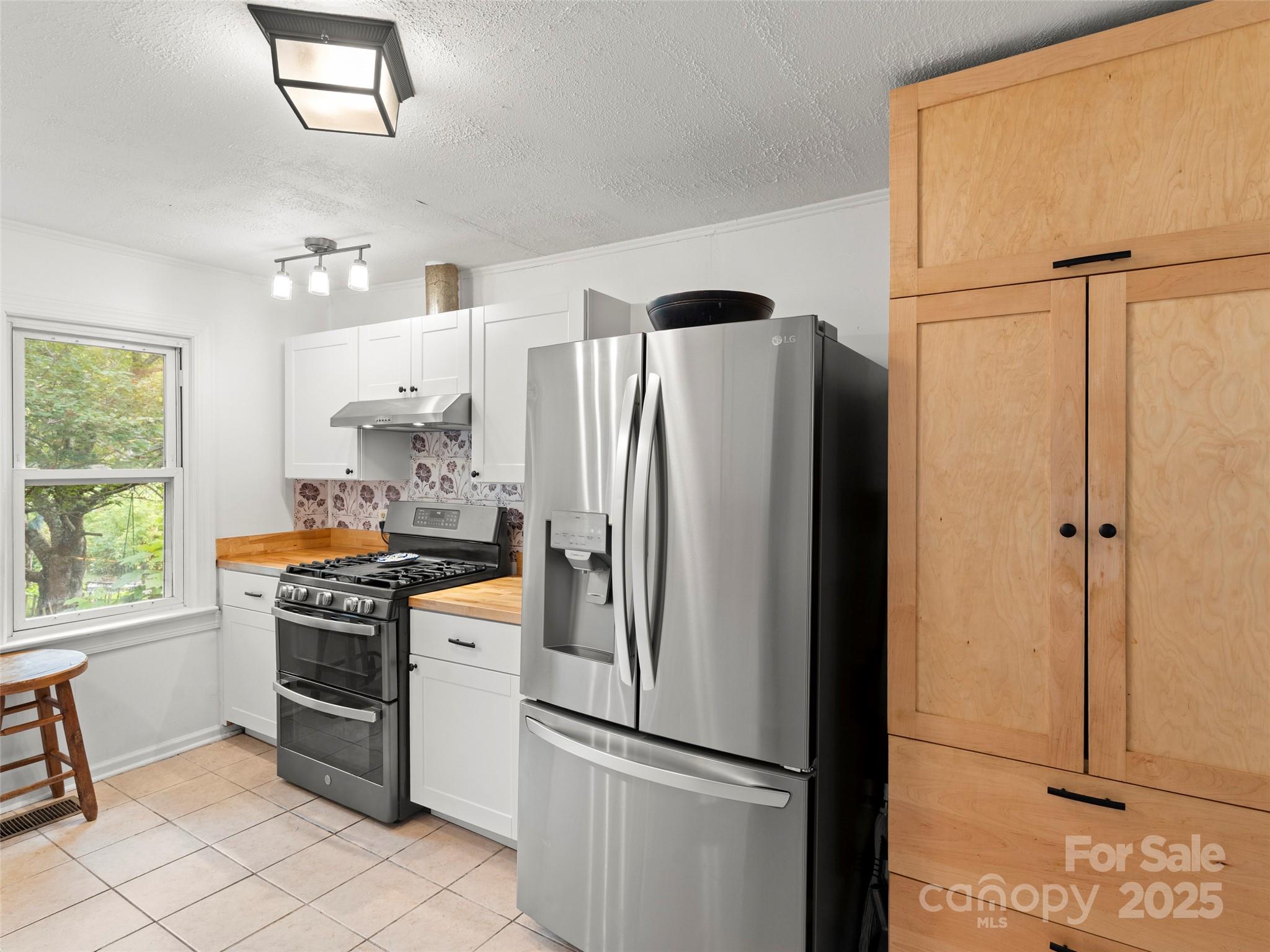 27 Barkn Cove Canton, NC 28716 - Photo 10 of 32 a kitchen with stainless steel appliances a refrigerator stove and sink