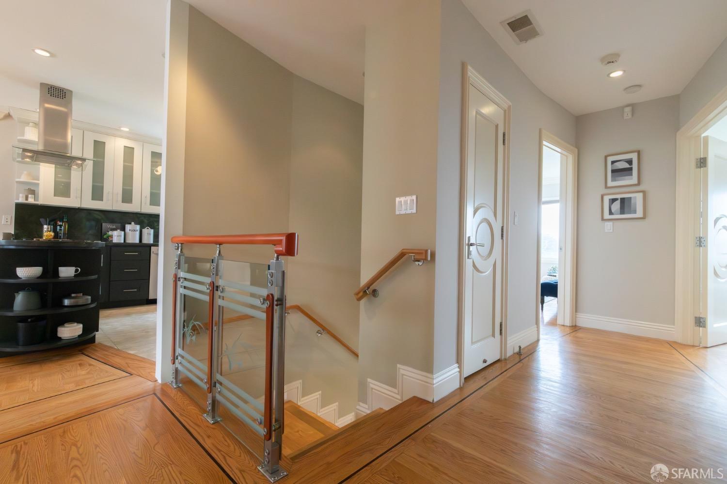 155 Upland Drive San Francisco, CA 94127 - Photo 18 of 43 a view of a hallway with wooden floor and livingroom with furniture