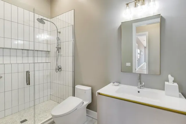 a bathroom with a sink toilet and shower