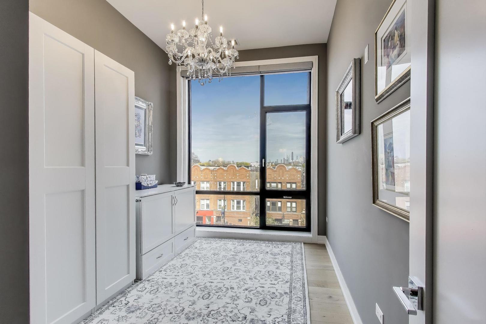 2405 West Iowa Street, Unit 405 Chicago, IL 60622 - Photo 23 of 35 a view of a big room with windows and chandelier