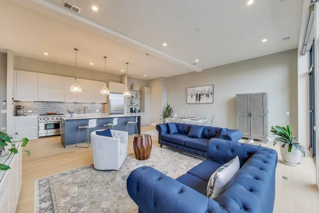 a living room with furniture and a kitchen