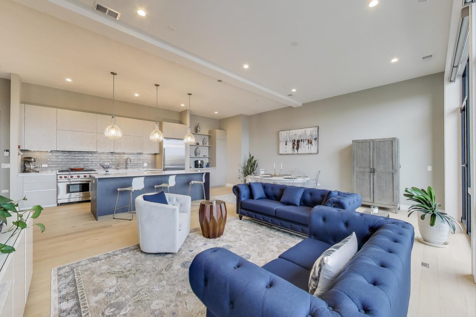 2405 West Iowa Street, Unit 405 Chicago, IL 60622 - Photo 3 of 35 a living room with furniture and a kitchen