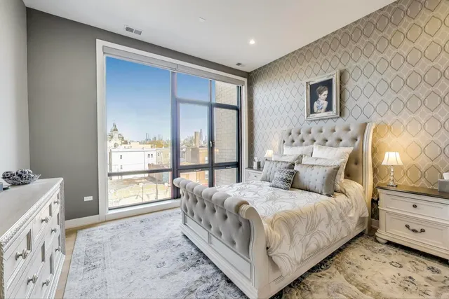 a bedroom with a bed and a large window