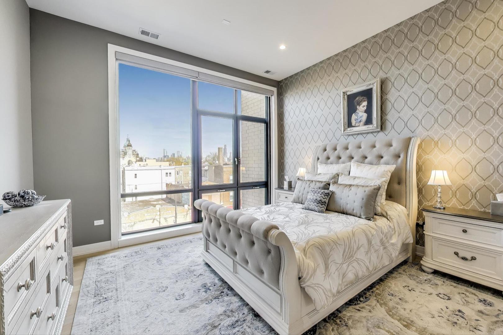 2405 West Iowa Street, Unit 405 Chicago, IL 60622 - Photo 8 of 35 a bedroom with a bed and a large window