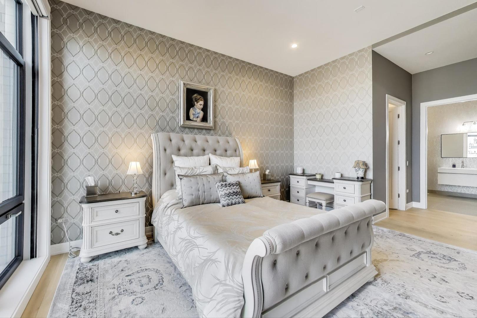 2405 West Iowa Street, Unit 405 Chicago, IL 60622 - Photo 9 of 35 a spacious bedroom with two beds and a couch