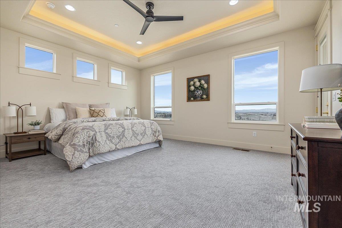 27202 Iron Horse Caldwell, ID 83607 - Photo 19 of 39 Bedroom featuring light carpet, a ceiling fan, recessed lighting, and a tray ceiling