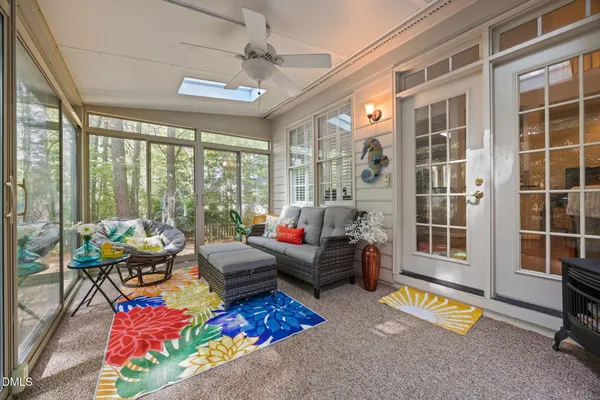 a living room with furniture and a floor to ceiling window