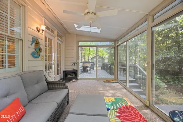 a living room with furniture and a floor to ceiling window