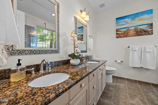 a bathroom with a double vanity sink and a mirror