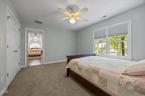 a bedroom with a bed and a chandelier