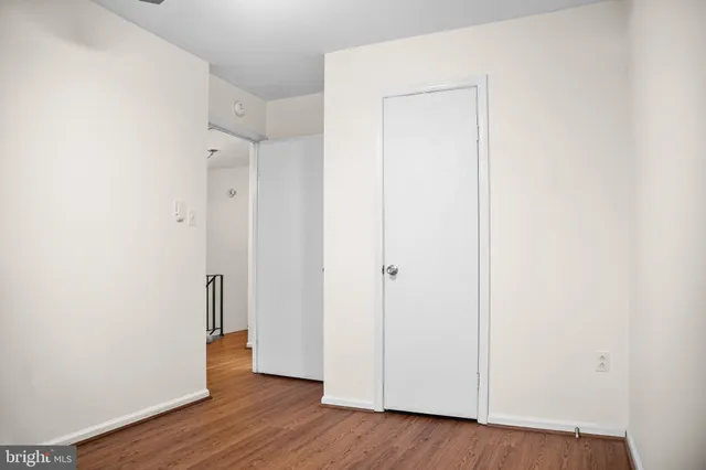 a view of a room with wooden floor