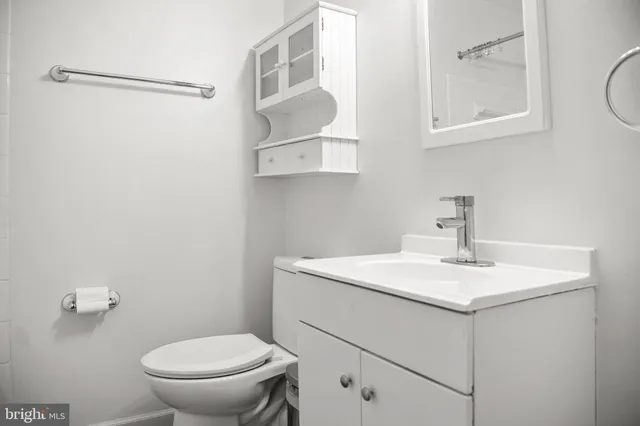 a bathroom with a sink toilet and vanity