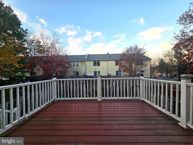 a view of balcony with wooden floor and fence