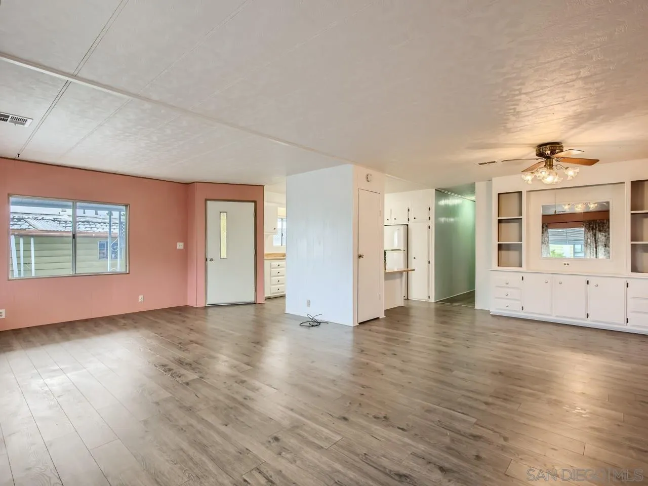 104 Havenview Lane Oceanside, CA 92056 - Photo 2 of 16 an empty room with wooden floor and windows
