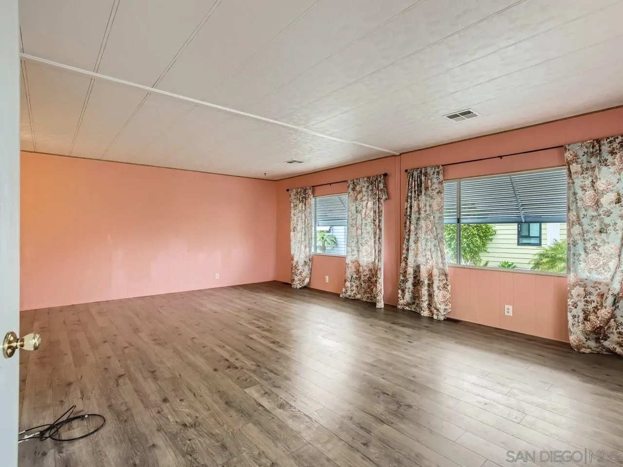 104 Havenview Lane Oceanside, CA 92056 - Photo 4 of 16 an empty room with wooden floor and windows