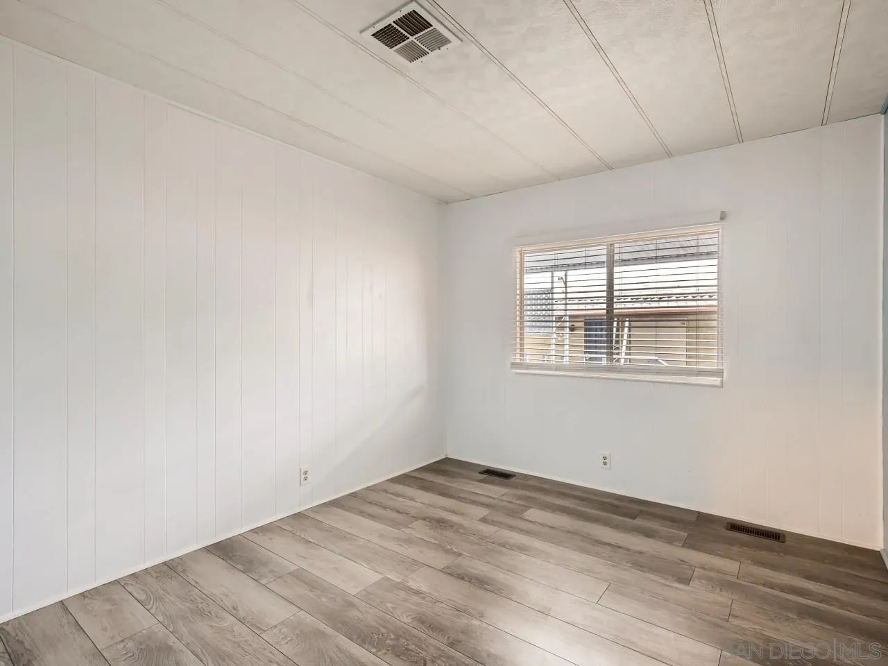 104 Havenview Lane Oceanside, CA 92056 - Photo 6 of 16 an empty room with wooden floor and windows