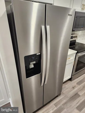 a view of hallway with wooden floor