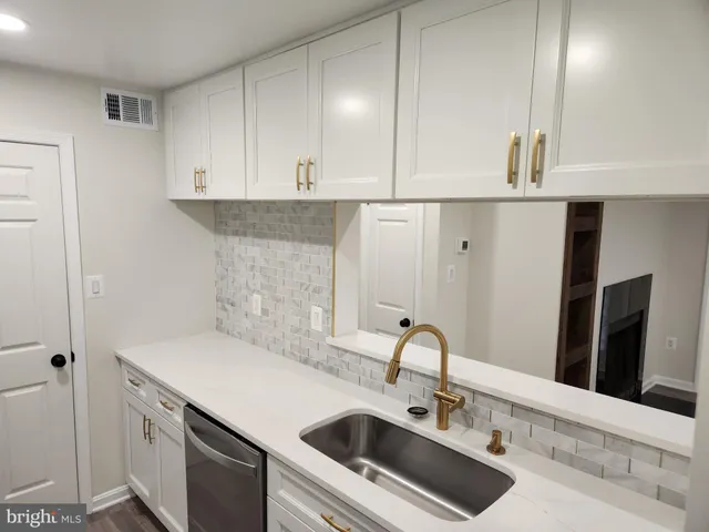 a stove top oven sitting inside of a kitchen