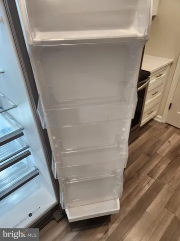 a view of walk in closet with empty racks