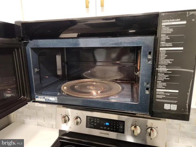 a stove top oven sitting inside of a kitchen