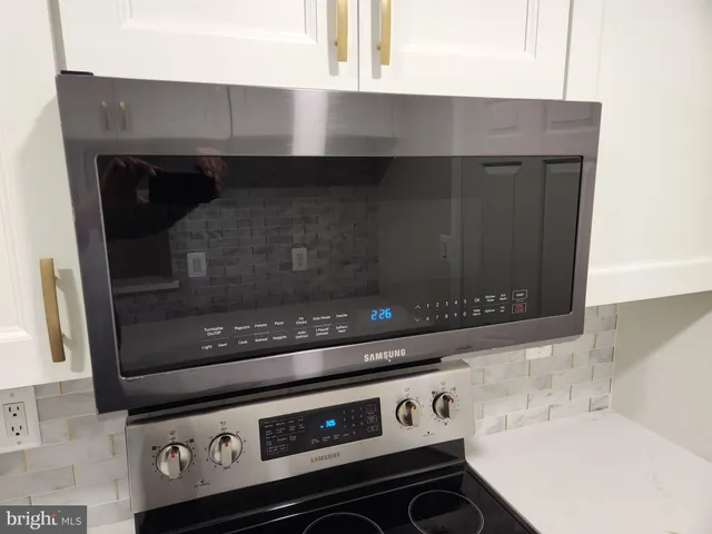 a stove top oven sitting inside of a kitchen