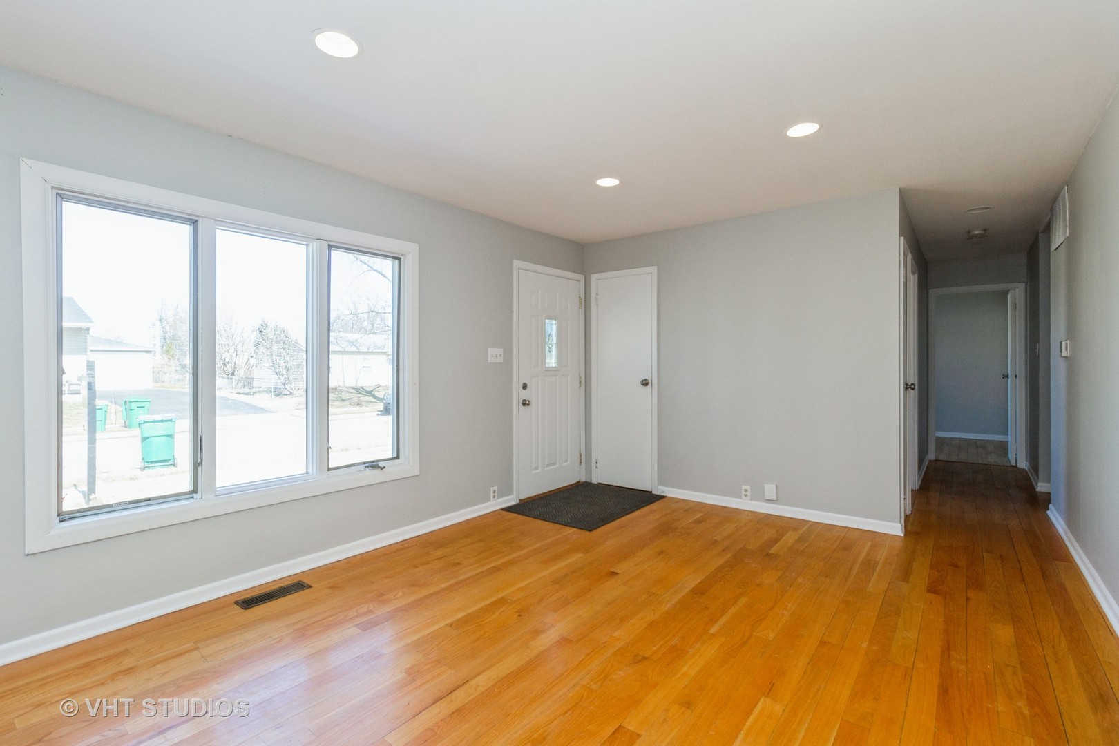 207 Haller Avenue Romeoville, IL 60446 - Photo 2 of 10 a view of an empty room with wooden floor and a window
