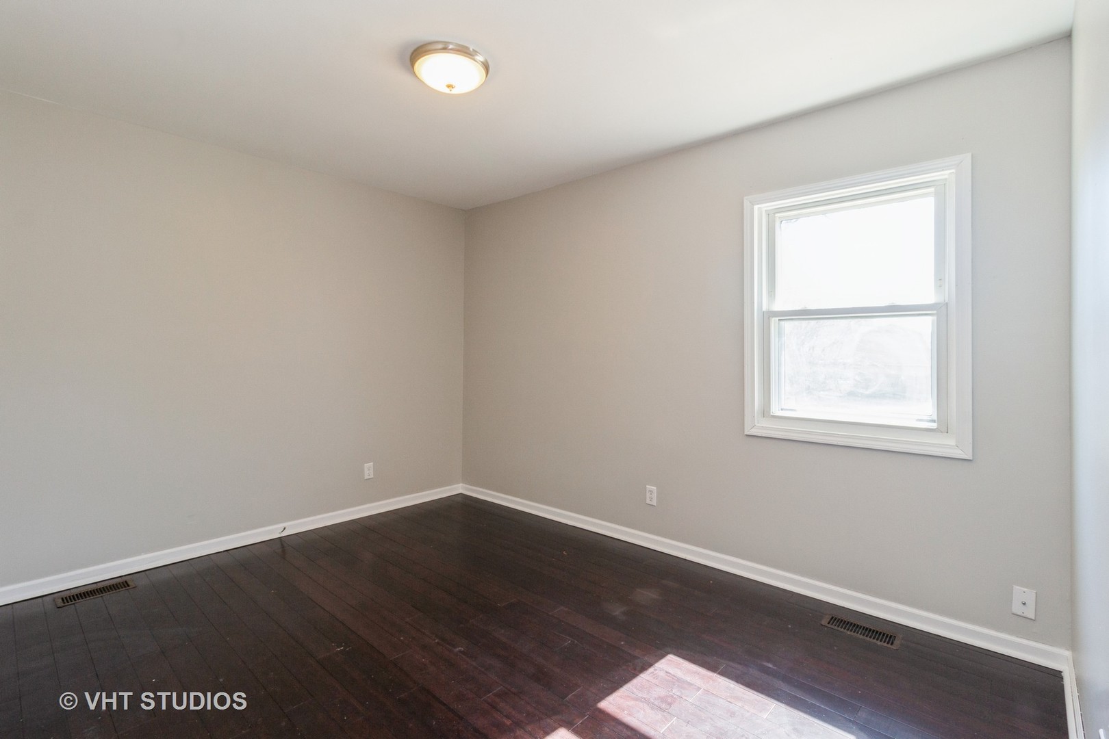 207 Haller Avenue Romeoville, IL 60446 - Photo 5 of 10 an empty room with wooden floor and windows