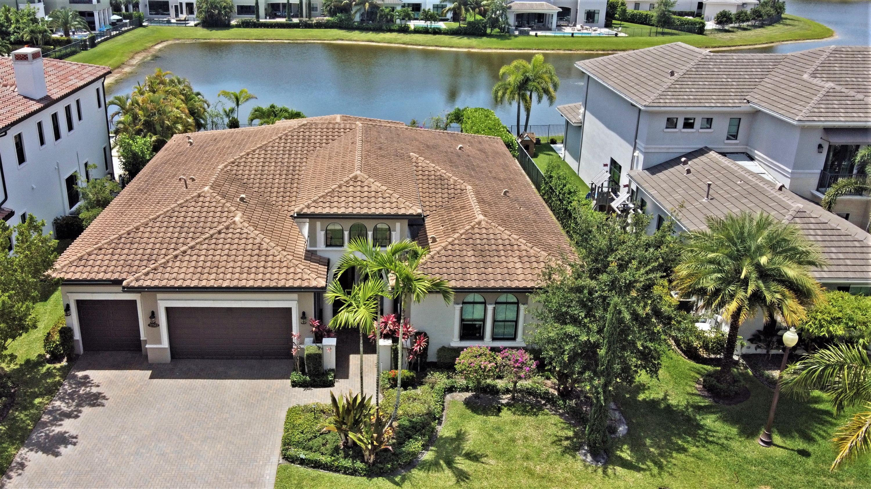 an aerial view of a house with swimming pool and outdoor seating