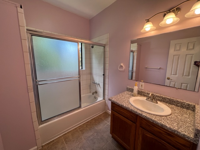 18-1976 Nau Nani Road Mountain View, HI 96771 - Photo 12 of 25 a bathroom with a granite countertop sink and a mirror