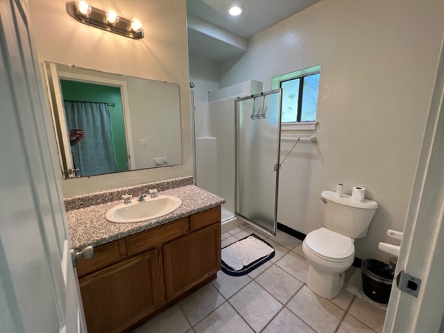 18-1976 Nau Nani Road Mountain View, HI 96771 - Photo 17 of 25 a bathroom with a granite countertop toilet sink and mirror