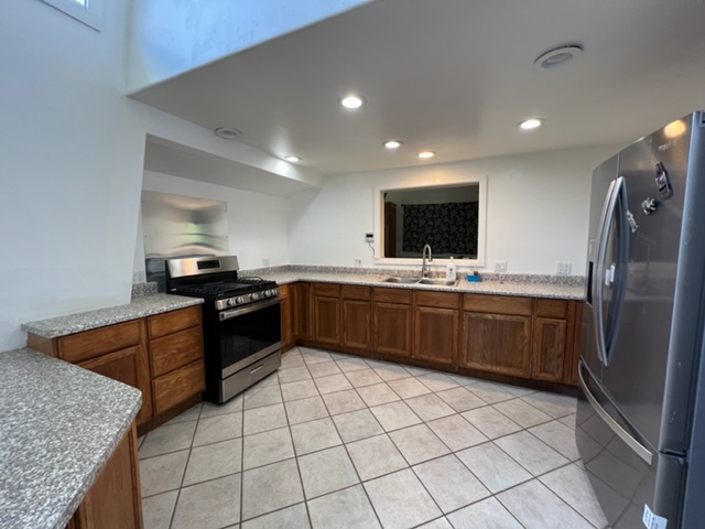 18-1976 Nau Nani Road Mountain View, HI 96771 - Photo 2 of 25 a kitchen with stainless steel appliances a sink stove top oven and cabinets